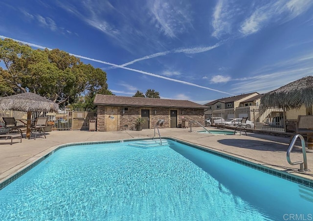 pool featuring a gazebo, a patio area, and fence
