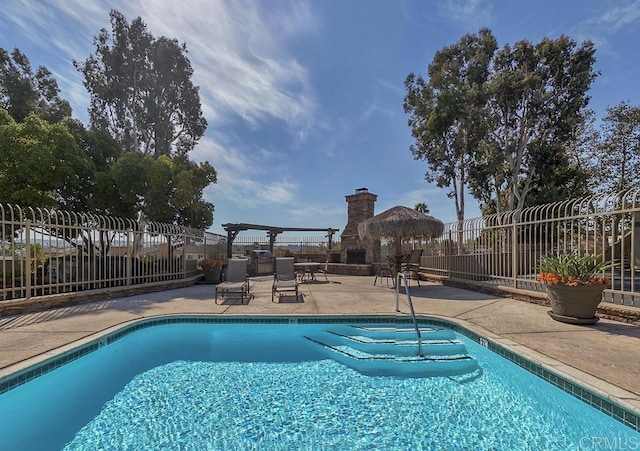 pool with a patio and fence