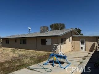 back of property featuring central AC unit and a patio