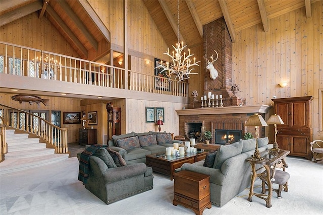 27990 Peninsula Dr N, Lake Arrowhead, CA 92352 - living area with carpet floors, a brick fireplace, stairs, wooden walls, and a notable chandelier