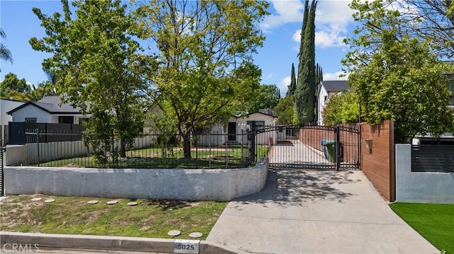 5025 Noble Ave, Sherman Oaks, CA 91403 - view of front of house with driveway, a fenced front yard, and a gate