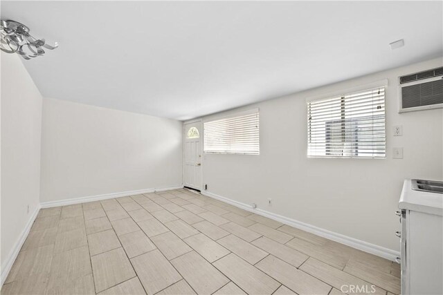 5025 Noble Ave, Sherman Oaks, CA 91403 - unfurnished room featuring a wall mounted AC and baseboards