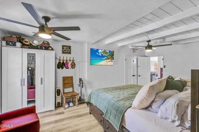 bedroom with beamed ceiling, ceiling fan, and light wood-style floors