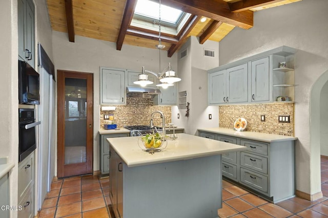 308 Topa Topa Dr, Ojai, CA 93023 - kitchen featuring light countertops, open shelves, visible vents, a skylight, and black appliances