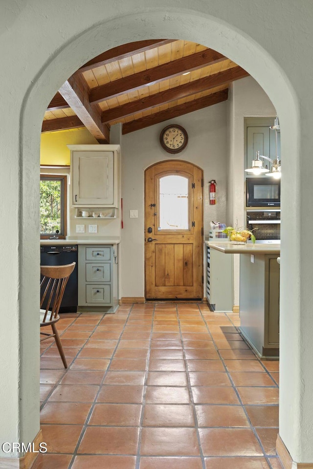308 Topa Topa Dr, Ojai, CA 93023 - interior space with light tile patterned floors, black appliances, beam ceiling, arched walkways, and wooden ceiling