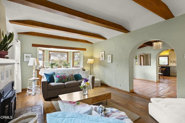 308 Topa Topa Dr, Ojai, CA 93023 - living room featuring a wealth of natural light, arched walkways, beam ceiling, and wood finished floors