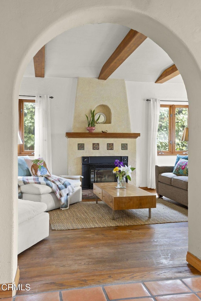 308 Topa Topa Dr, Ojai, CA 93023 - living room with beamed ceiling, arched walkways, a large fireplace, and hardwood / wood-style floors