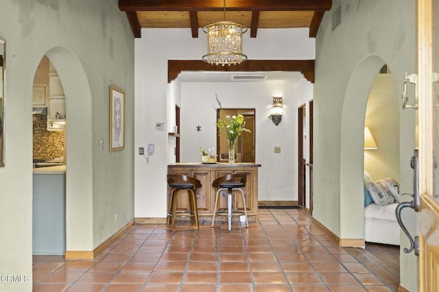 308 Topa Topa Dr, Ojai, CA 93023 - tiled foyer entrance featuring arched walkways, a chandelier, and a wooden ceiling with exposed beams