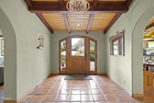 308 Topa Topa Dr, Ojai, CA 93023 - foyer entrance featuring a wood ceiling with exposed beams, arched walkways, a chandelier, and tile patterned floors