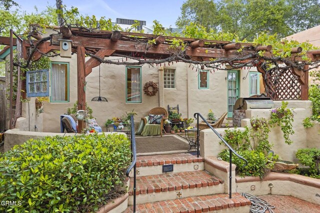 308 Topa Topa Dr, Ojai, CA 93023 - rear view of house with a pergola and stucco siding