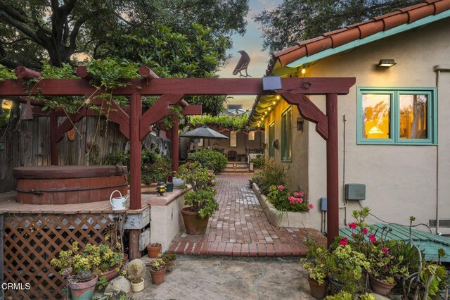 308 Topa Topa Dr, Ojai, CA 93023 - patio terrace at dusk featuring a covered hot tub and a patio