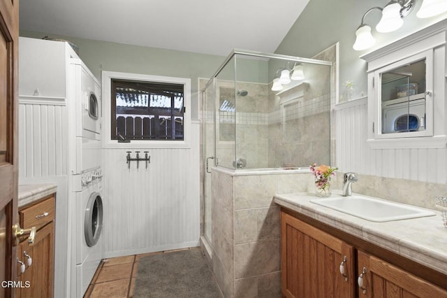 308 Topa Topa Dr, Ojai, CA 93023 - full bathroom with stacked washer / drying machine, vanity, a shower stall, tile patterned flooring, and a wainscoted wall