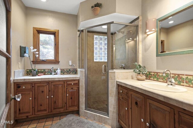 308 Topa Topa Dr, Ojai, CA 93023 - full bathroom featuring two vanities, a stall shower, and tile patterned floors