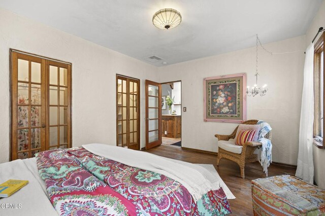 308 Topa Topa Dr, Ojai, CA 93023 - bedroom with wood finished floors, french doors, and a chandelier