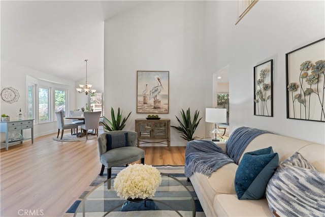 43 Ashbrook, Irvine, CA 92604 - living area with baseboards, high vaulted ceiling, an inviting chandelier, and wood finished floors
