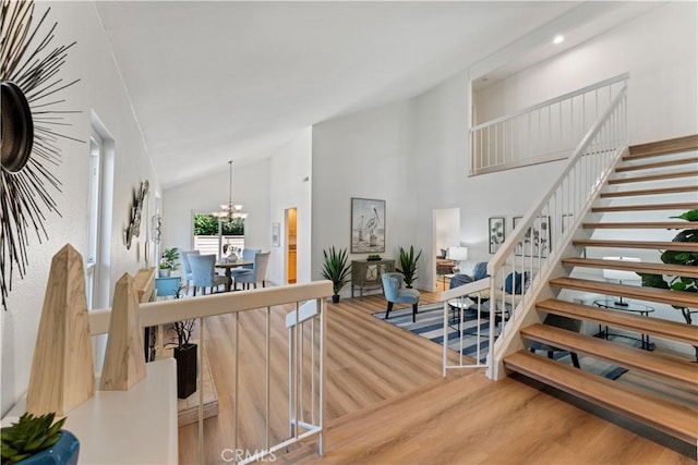 43 Ashbrook, Irvine, CA 92604 - staircase with wood finished floors, high vaulted ceiling, and a notable chandelier