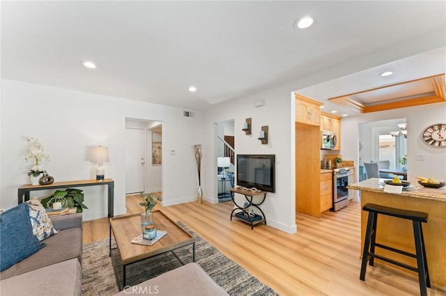 43 Ashbrook, Irvine, CA 92604 - living room featuring a tray ceiling, light wood finished floors, visible vents, and recessed lighting