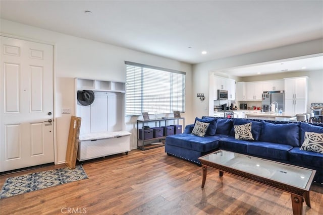 living area with wood finished floors and recessed lighting