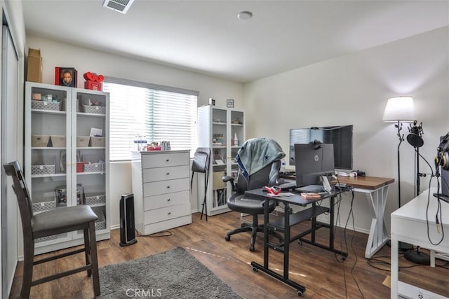 office space featuring visible vents and wood finished floors