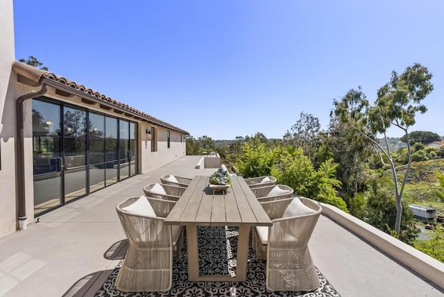 balcony with a patio area and outdoor dining area
