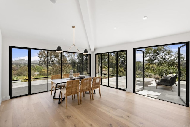 sunroom with a healthy amount of sunlight and beam ceiling