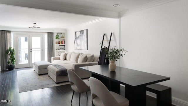 interior space featuring an inviting chandelier, dark wood-style flooring, ornamental molding, and french doors