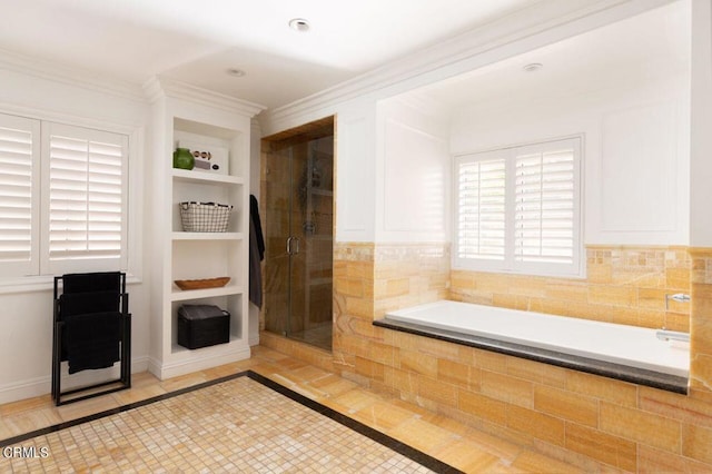 full bath featuring a shower stall, a bath, built in features, and crown molding