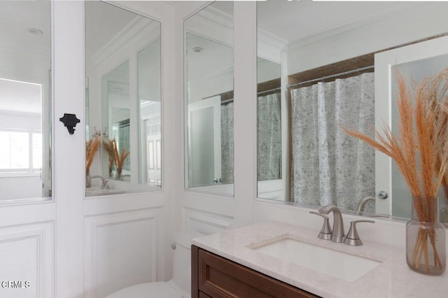 bathroom with toilet, vanity, and a shower with curtain