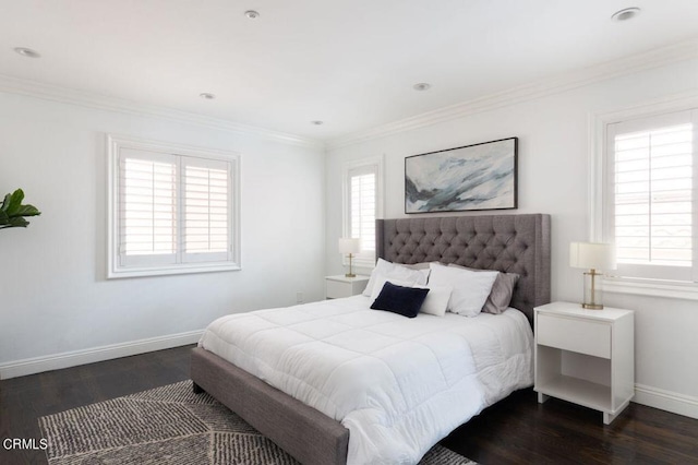 bedroom with baseboards, multiple windows, crown molding, and wood finished floors