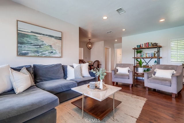 living area with wood finished floors, visible vents, and recessed lighting