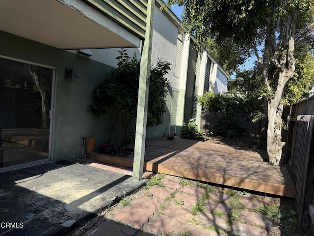 view of patio with fence and a deck