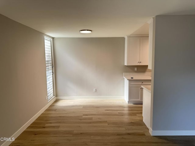 interior space featuring light wood finished floors and baseboards