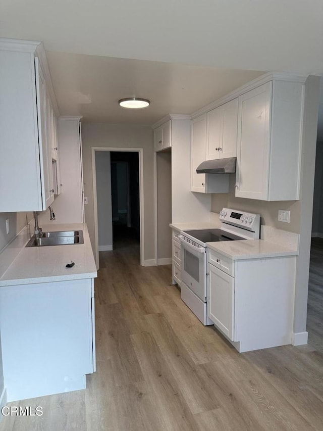 kitchen with white cabinets, white range with electric stovetop, a sink, under cabinet range hood, and light wood-style flooring