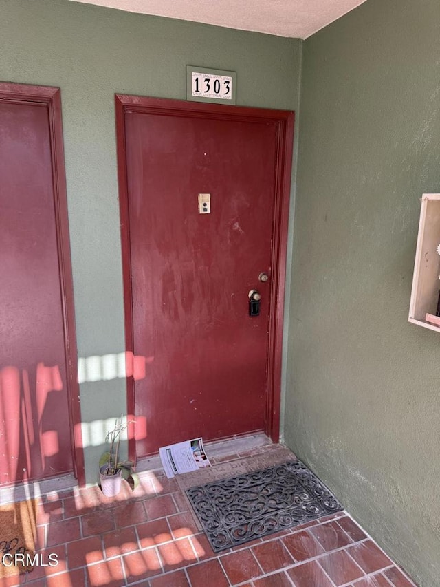 entrance to property featuring stucco siding