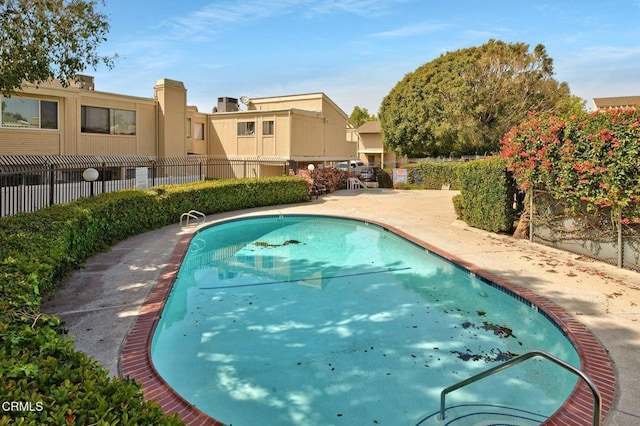 view of pool featuring a patio and fence