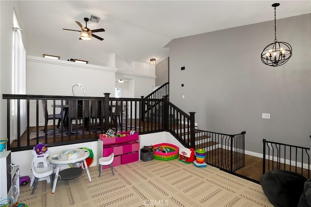 40824 Cobblestone Ct, Palmdale, CA 93551 - rec room with ceiling fan, wood finished floors, a chandelier, vaulted ceiling, and baseboards