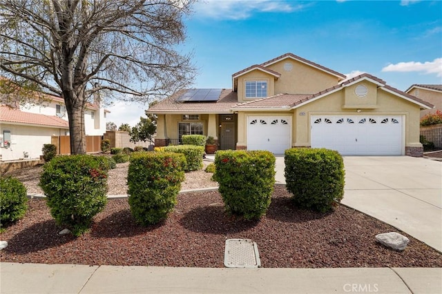 40824 Cobblestone Ct, Palmdale, CA 93551 - traditional home with stucco siding, roof mounted solar panels, concrete driveway, an attached garage, and a tile roof