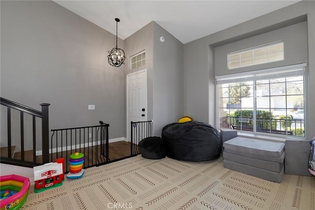 40824 Cobblestone Ct, Palmdale, CA 93551 - playroom featuring a chandelier, healthy amount of natural light, wood finished floors, and high vaulted ceiling