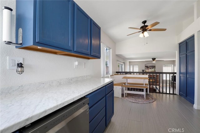 40824 Cobblestone Ct, Palmdale, CA 93551 - kitchen with blue cabinets, ceiling fan, dishwasher, and lofted ceiling