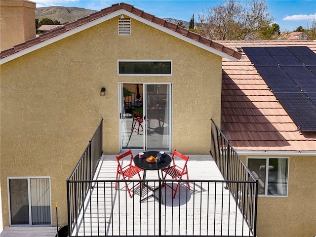 40824 Cobblestone Ct, Palmdale, CA 93551 - rear view of property featuring stucco siding, a balcony, and solar panels