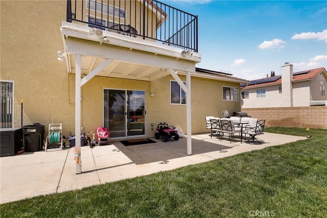 40824 Cobblestone Ct, Palmdale, CA 93551 - back of property featuring a balcony, stucco siding, and a patio area