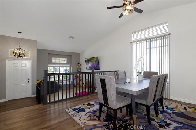 40824 Cobblestone Ct, Palmdale, CA 93551 - dining room featuring a ceiling fan, wood finished floors, a chandelier, baseboards, and high vaulted ceiling