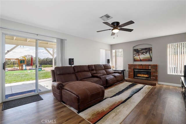 40824 Cobblestone Ct, Palmdale, CA 93551 - living area featuring wood finished floors, a ceiling fan, a brick fireplace, and baseboards
