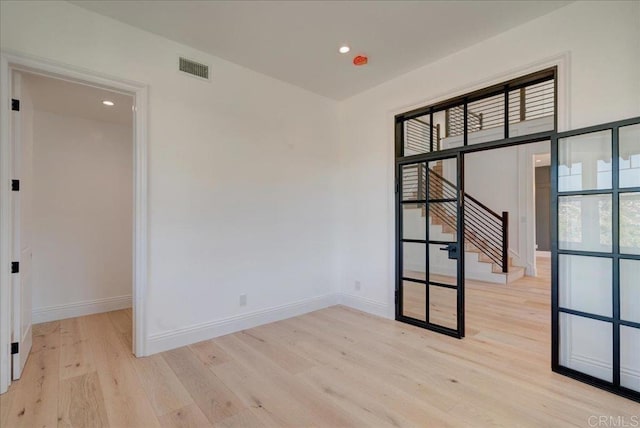 24321 Barona Mesa Rd, Ramona, CA 92065 - unfurnished room featuring visible vents, recessed lighting, stairway, light wood-style flooring, and baseboards