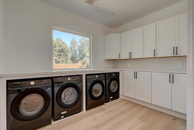 24321 Barona Mesa Rd, Ramona, CA 92065 - washroom with cabinet space, washing machine and clothes dryer, and light wood-type flooring