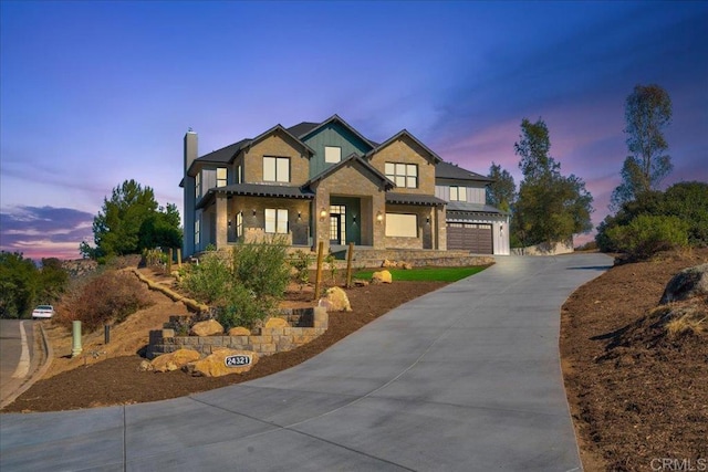 24321 Barona Mesa Rd, Ramona, CA 92065 - craftsman inspired home with concrete driveway, stone siding, a chimney, and an attached garage