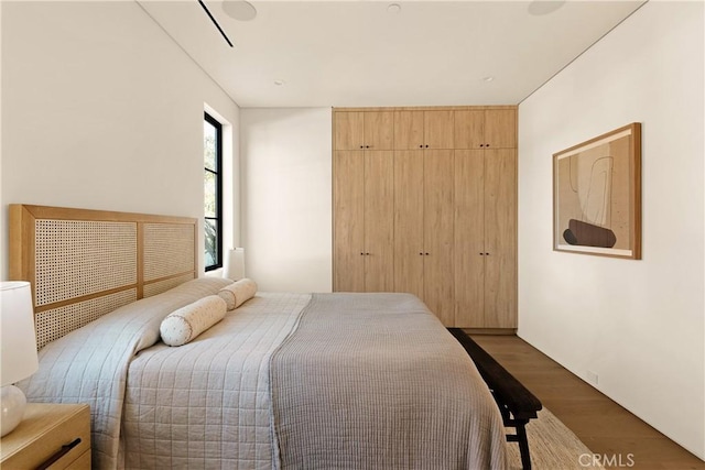 bedroom with a closet and wood finished floors