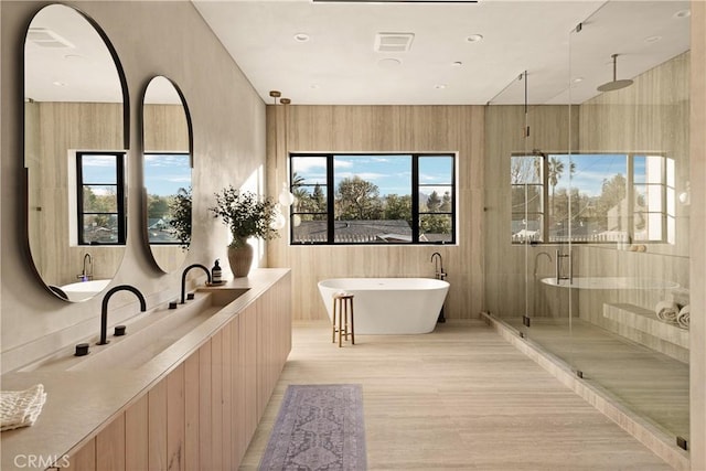 full bath featuring a soaking tub and a stall shower