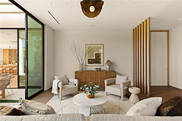 living area with expansive windows and wood finished floors
