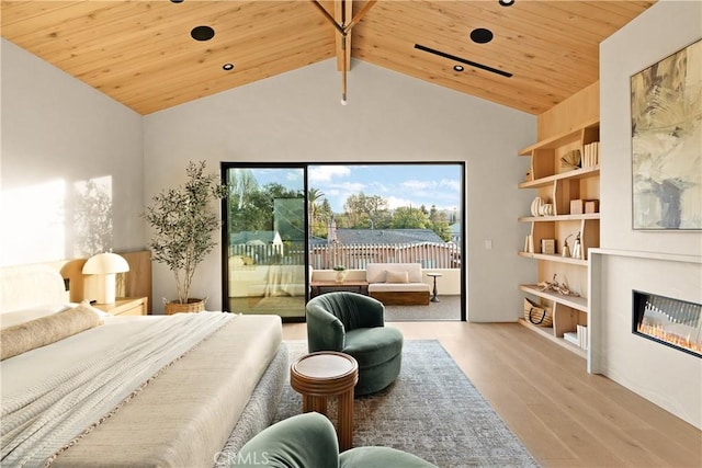 bedroom with a glass covered fireplace, lofted ceiling, access to outside, wooden ceiling, and light wood finished floors